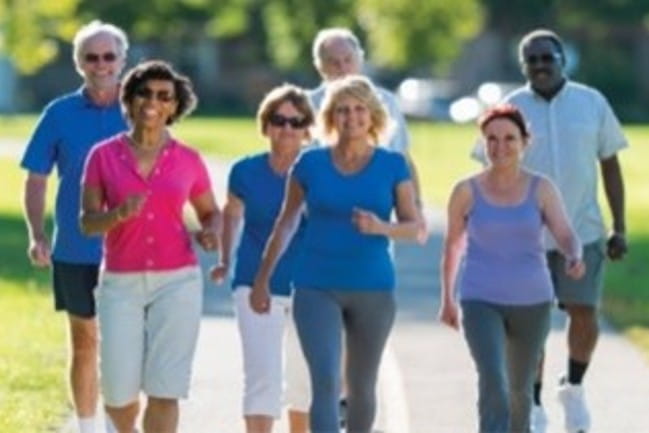 Group of smiling people walking.