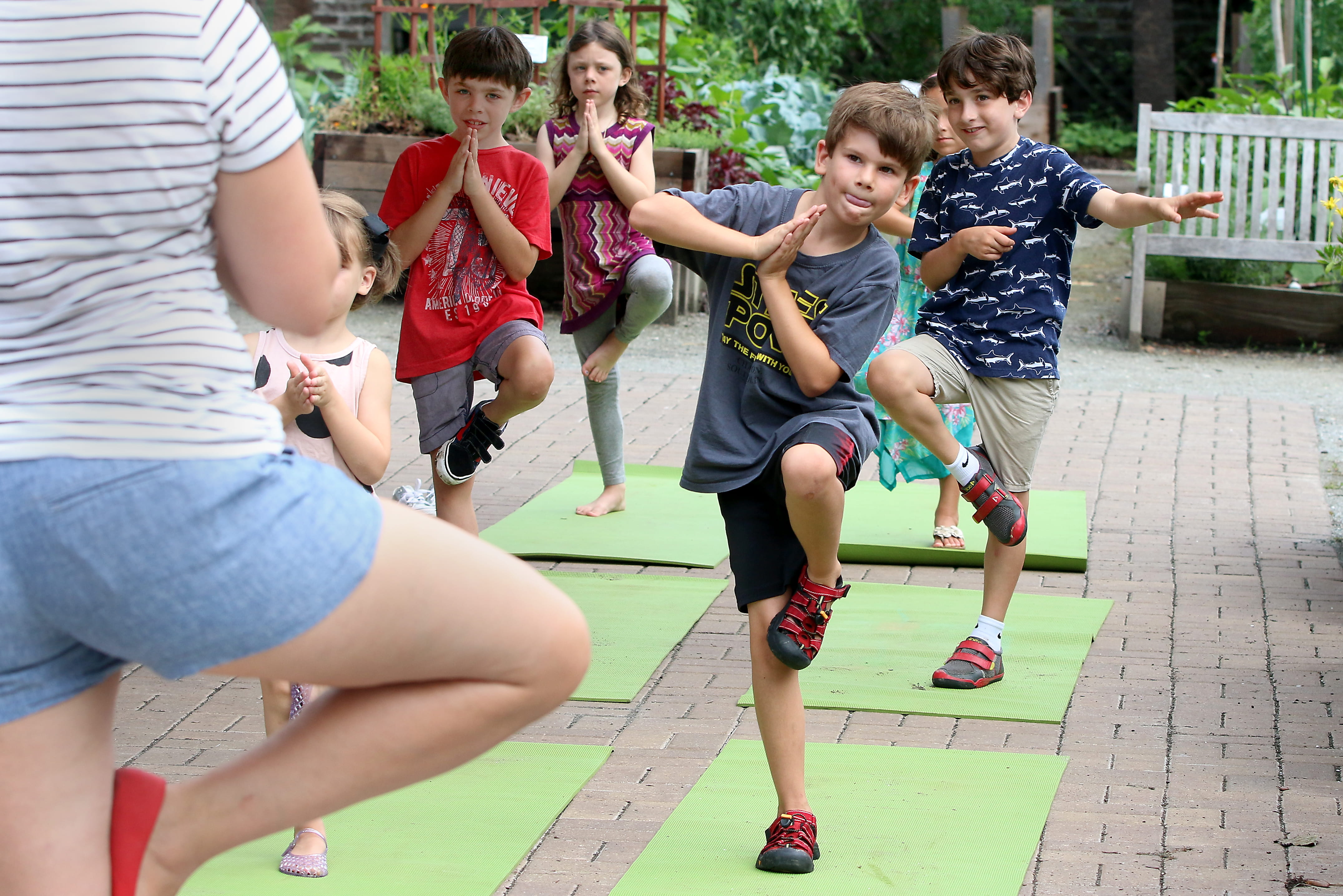 Children doing yoga with teacher